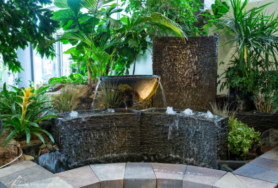 Custom indoor water wall fountain with tropical plants